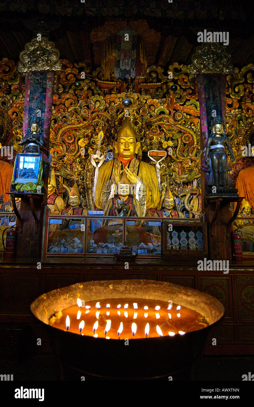 Illuminated candles in a vat of yak butter, Drepung, monastery, Lhasa, Tibet Stock Photo