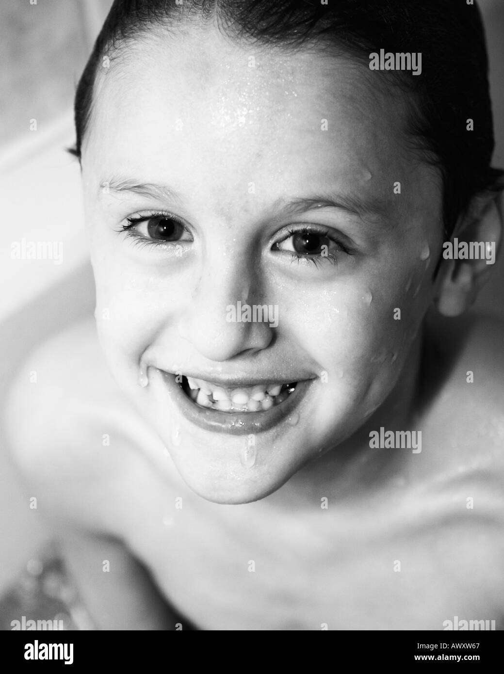 boy in bathtub about age 5 or 6 years old smiling at camera in black white Stock Photo