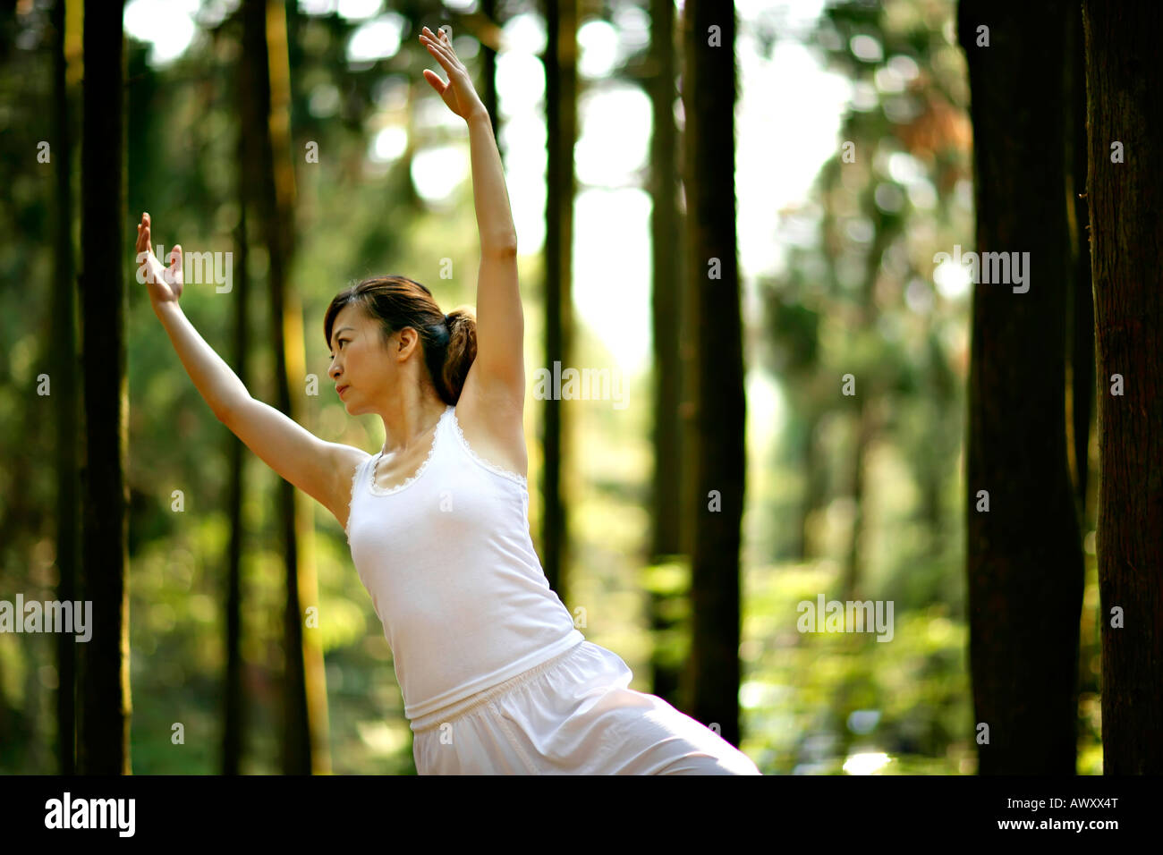 young women practice yoga in forest Stock Photo - Alamy