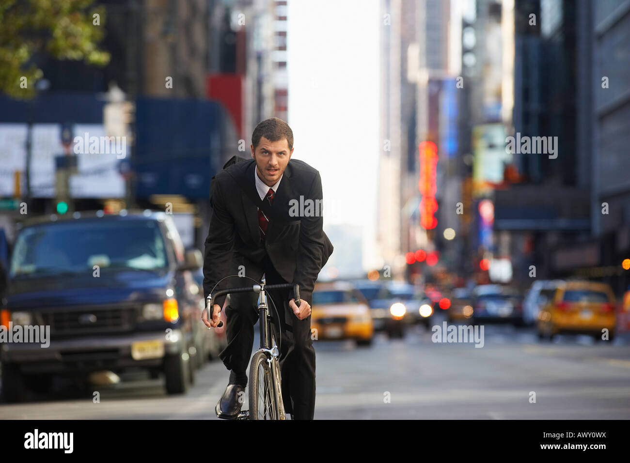 Man riding bicycle on street Stock Photo