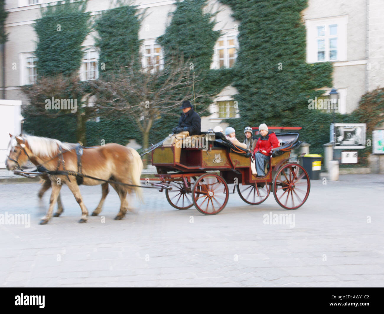 A tourist horse drawn carriage passes beside the cathedral in Salzburg Austria Stock Photo