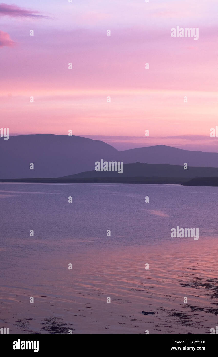 dh  SCAPA FLOW ORKNEY Misty sea Hoy hills lilac pink pastel evening light skies dusk sunset tranquil calm seascape sky Stock Photo