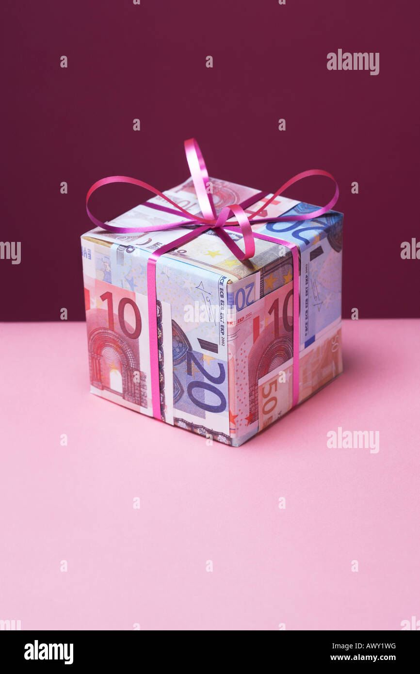 Small gift wrapped in Euro notes Stock Photo - Alamy