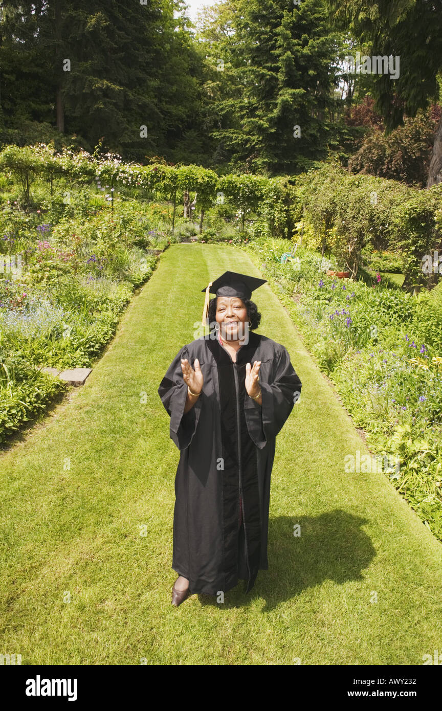 L Graduation Graduation day for woman in cap and gown Stock Photo - Alamy