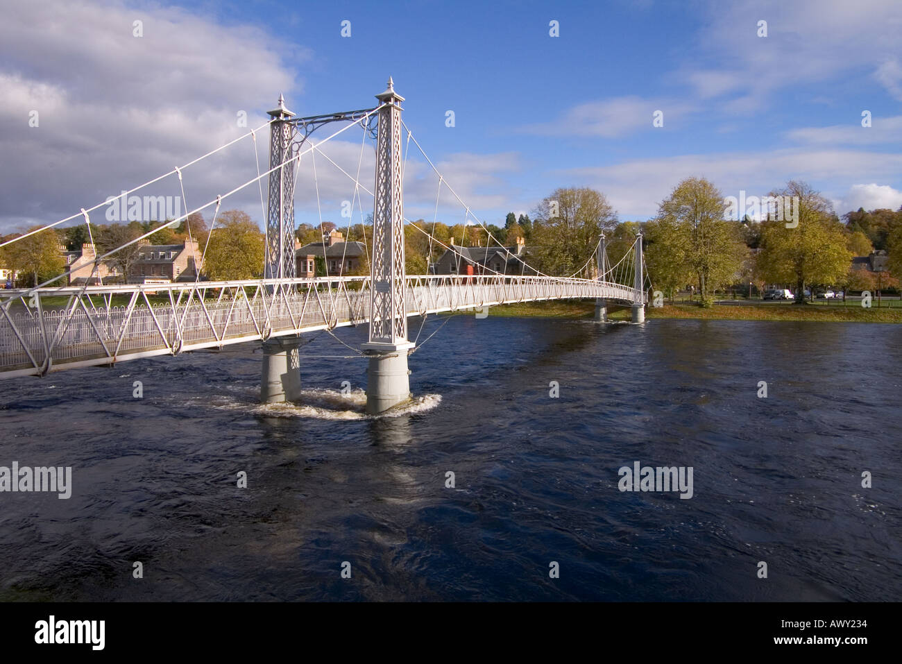 dh River Ness INVERNESS INVERNESSSHIRE Iron footbridge supension bridge river in full spate Stock Photo