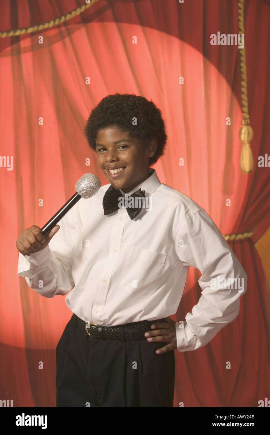 Boy on stage holding a microphone Stock Photo
