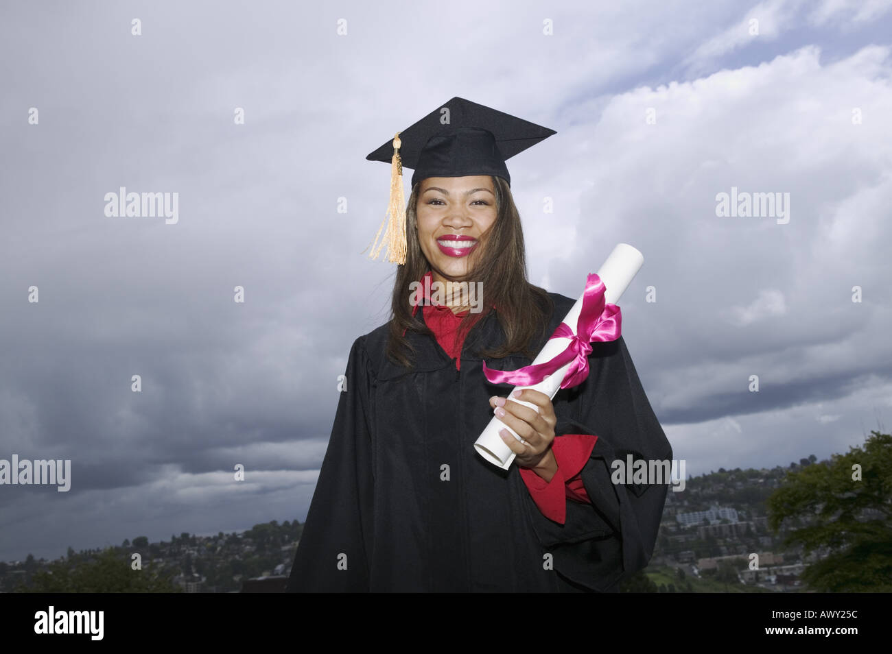 Female graduate holding her diploma Stock Photo - Alamy