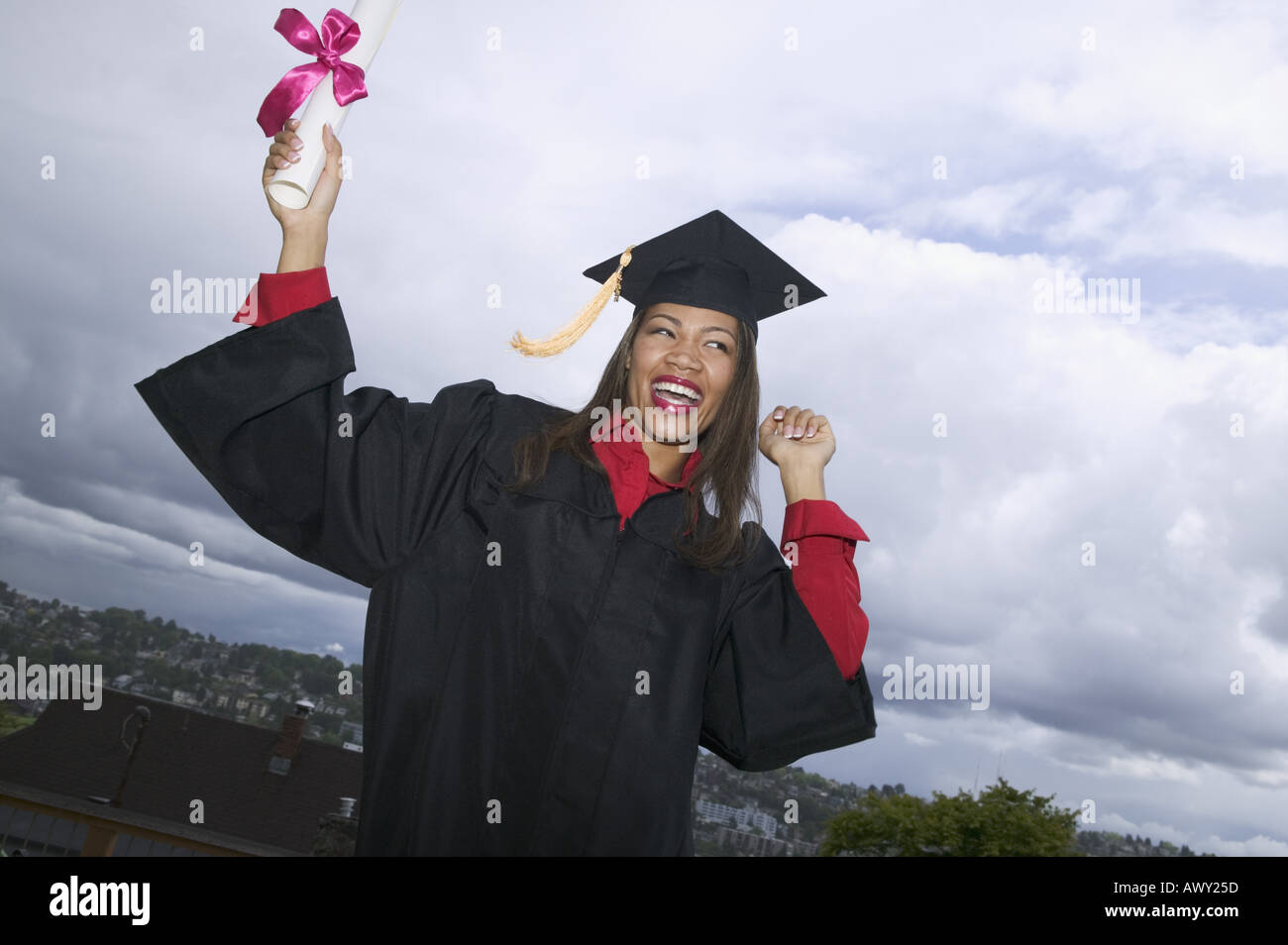 Female graduate holding her diploma Stock Photo - Alamy