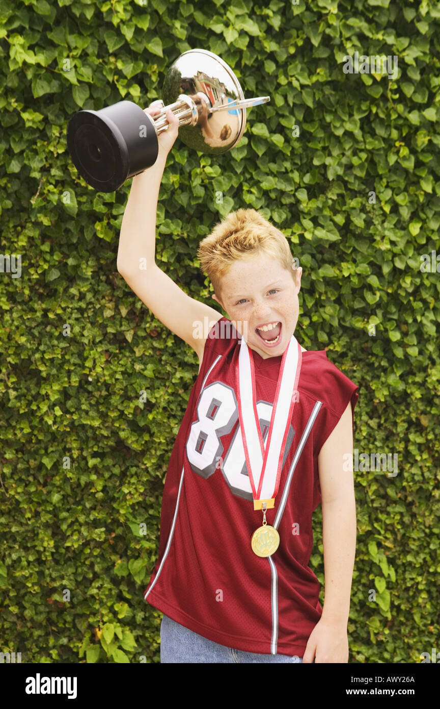 Boy holding a trophy Stock Photo - Alamy