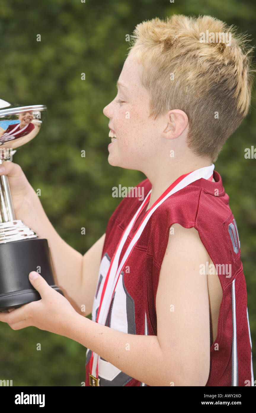 Profile of a boy holding a trophy Stock Photo