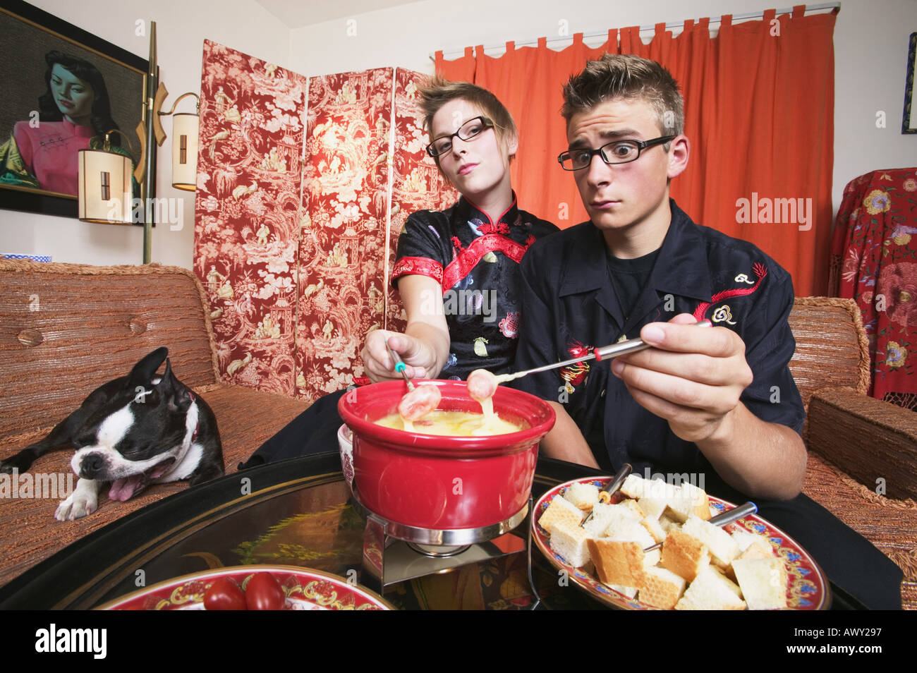 Couple at home having fondue Stock Photo