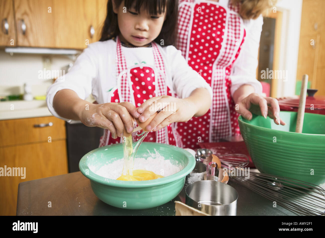 A female adult and child cooking together Stock Photo