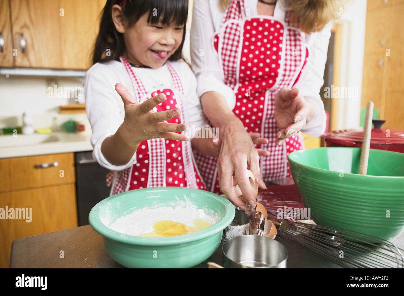A female adult and child cooking together Stock Photo