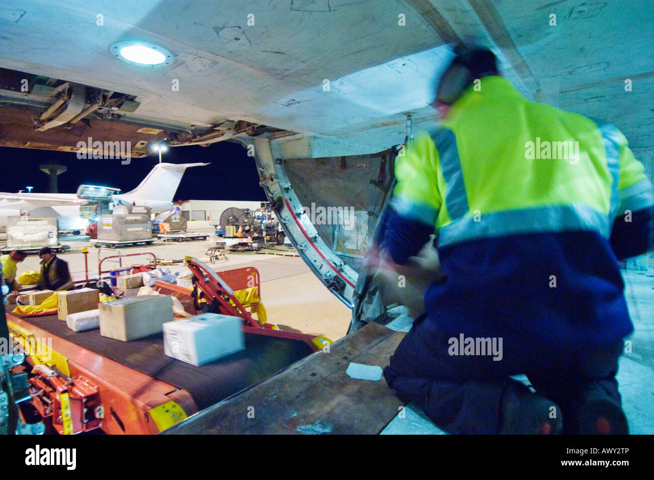 Loading freight into cargo hold of aircraft Stock Photo - Alamy
