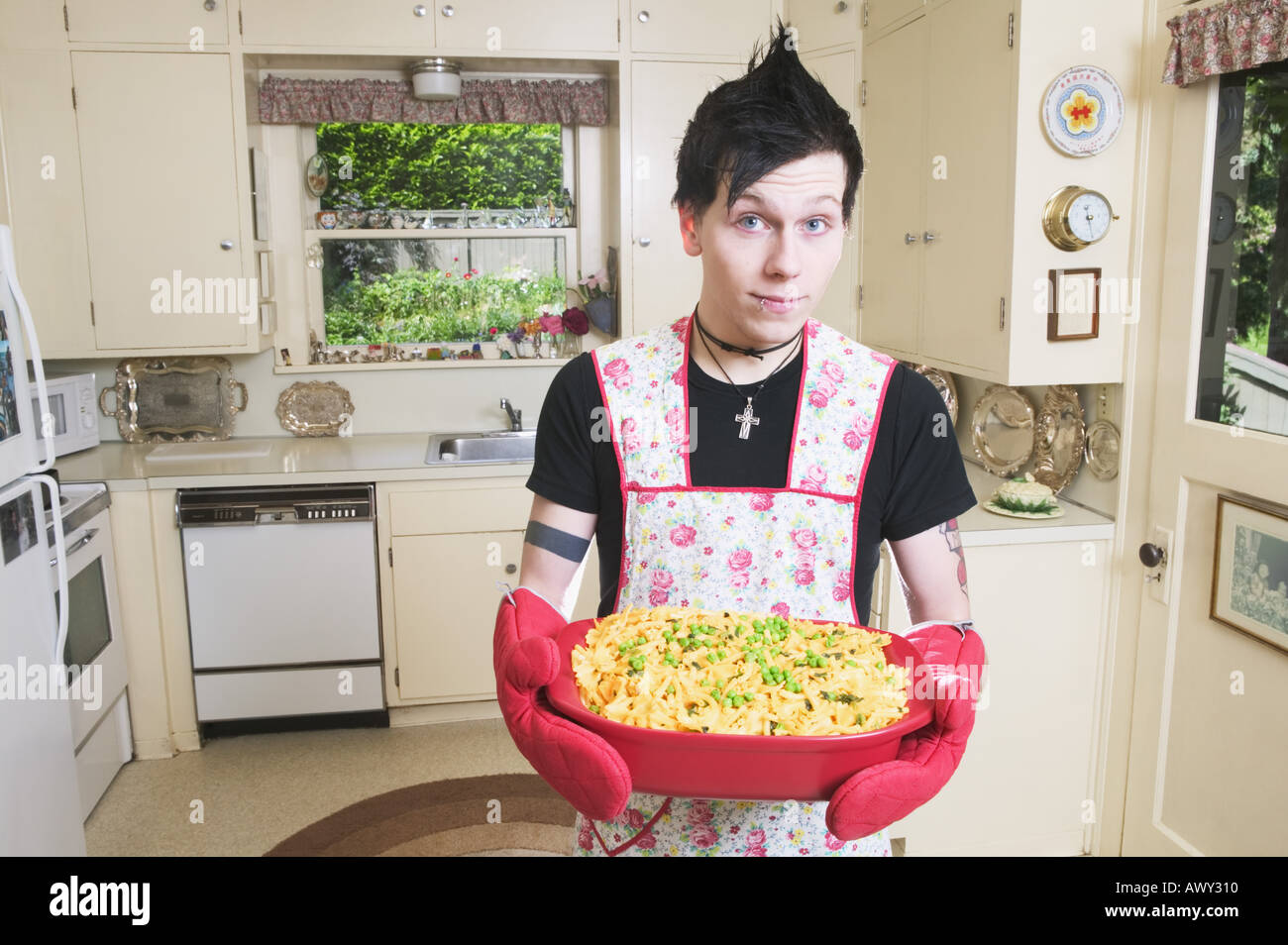 Man in kitchen holding a casserole Stock Photo