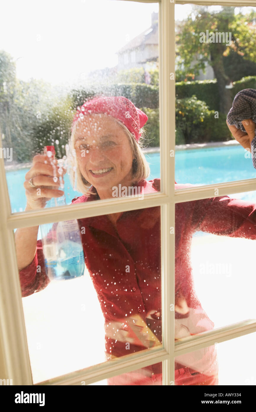 Woman cleaning windows Stock Photo