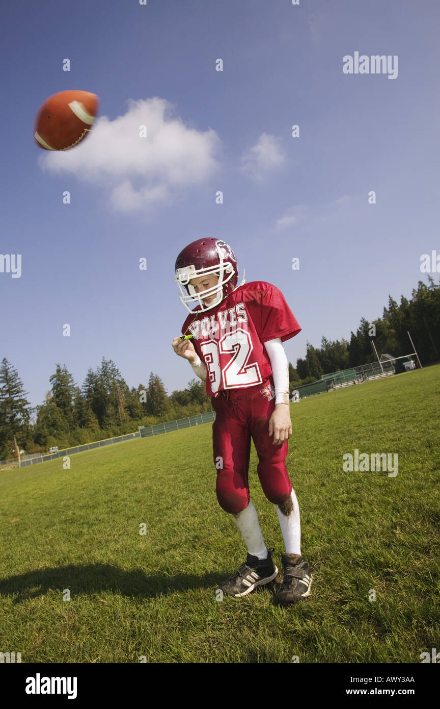Football player about to get hit with ball Stock Photo