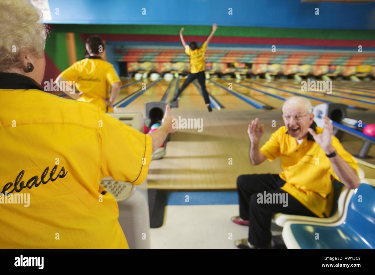 Bowling team cheering for a teammate Stock Photo