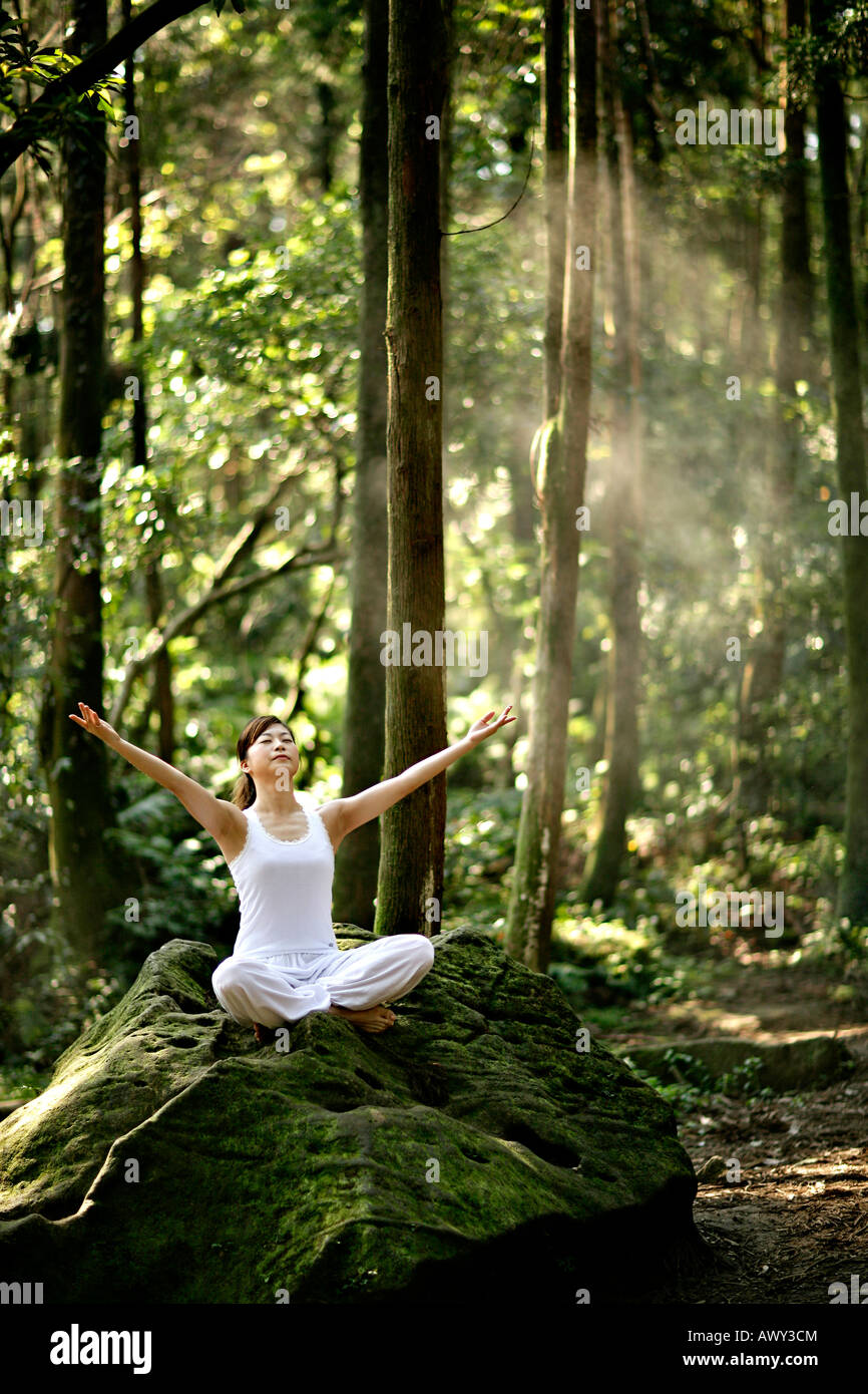 young woman practice yoga in forest Stock Photo - Alamy