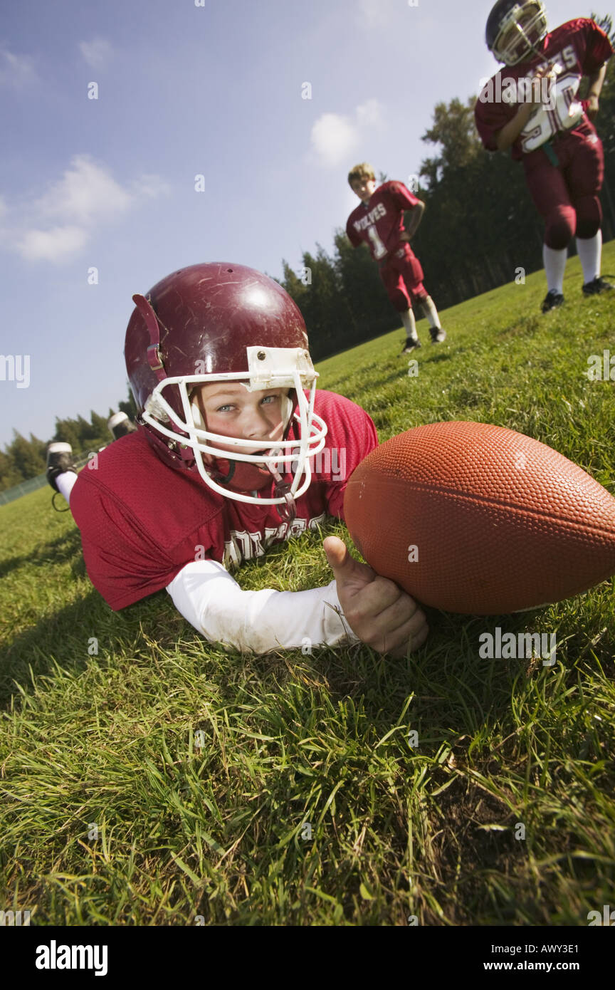 Young football player on the ground Stock Photo