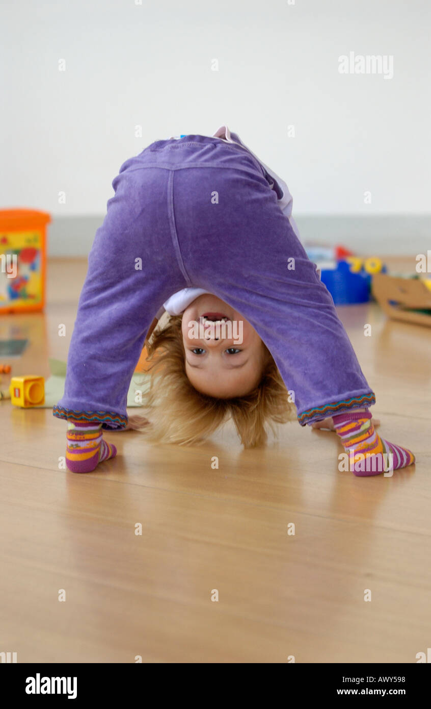 Toddler looking through legs Stock Photo Alamy