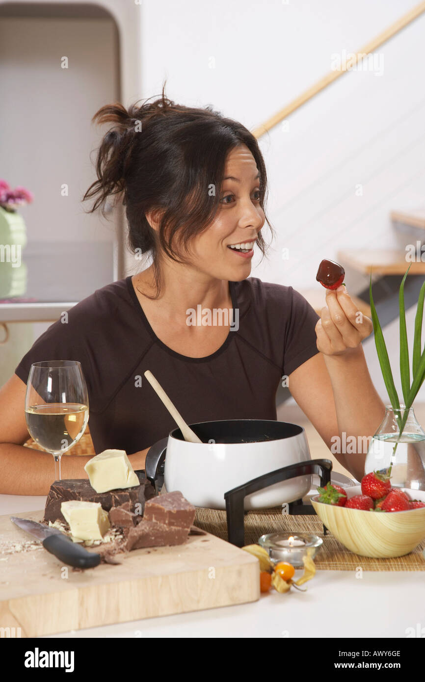 Woman Eating Chocolate Fondue Stock Photo