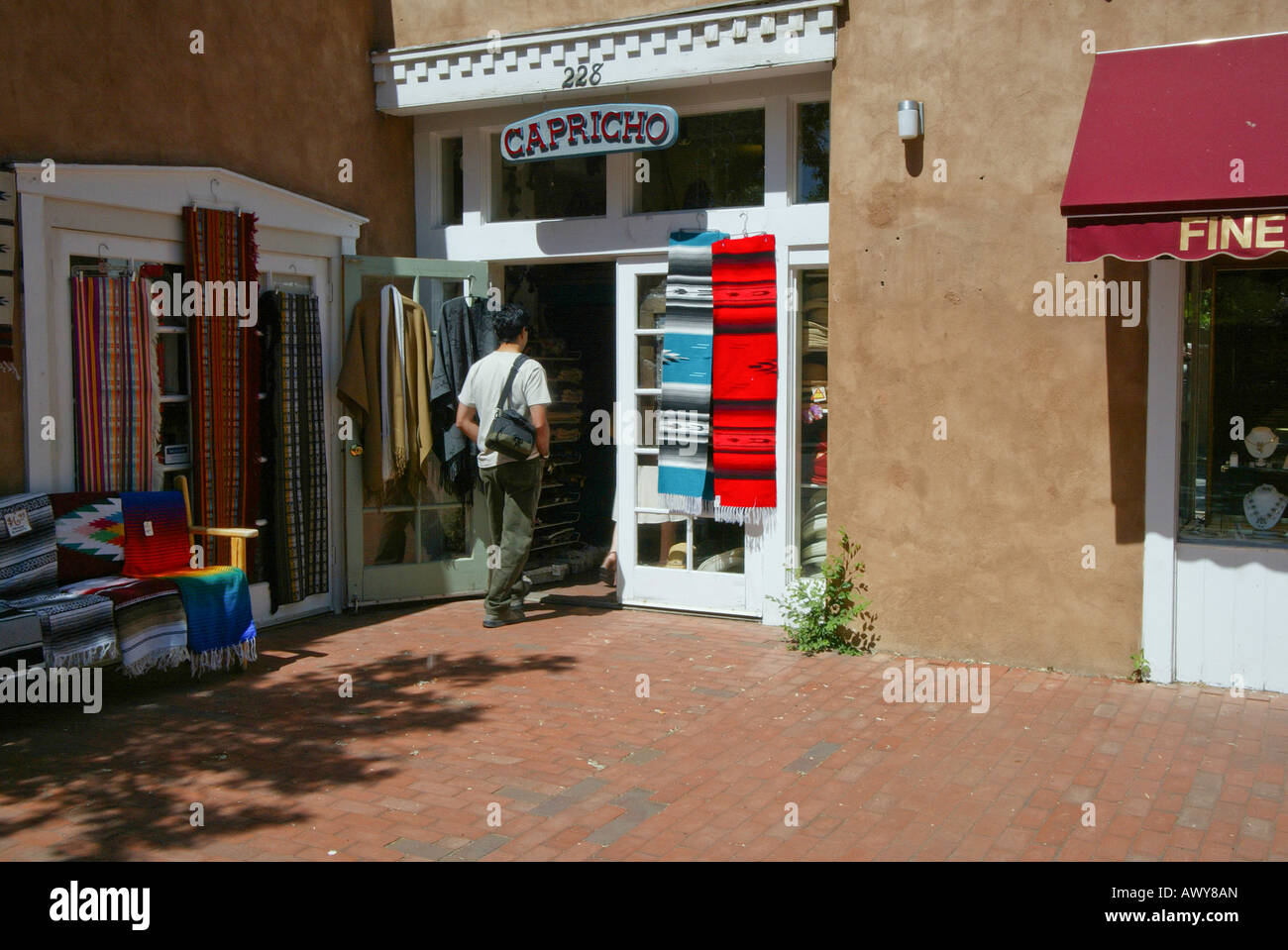 Customer enters gallery featuring Indian blankets in Santa Fe New Mexico USA Stock Photo