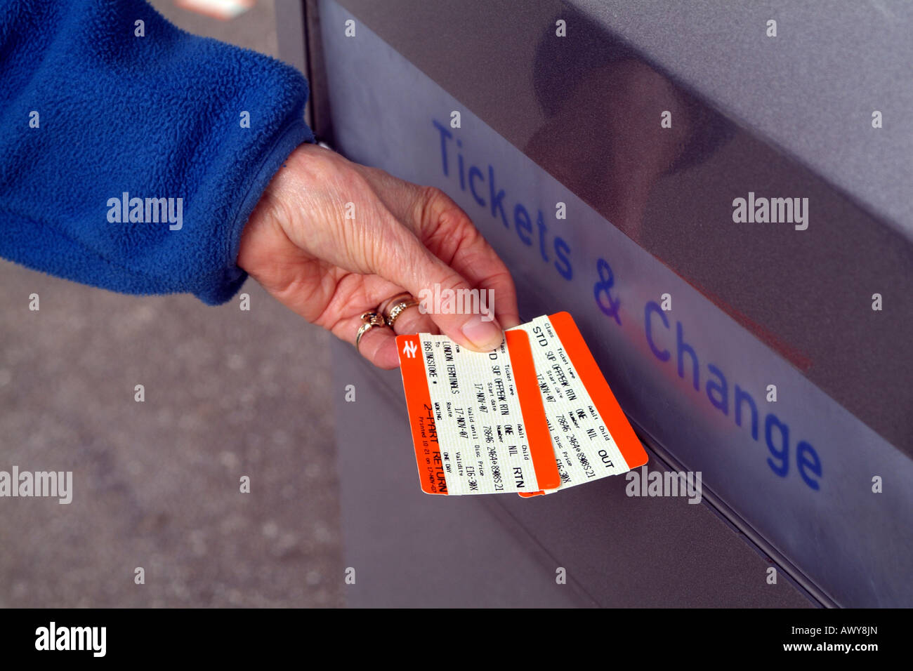 Customers Hand with Two Part Return Tickets for use with South West Trains Self Service Railway Ticket Machine Dispenser Stock Photo