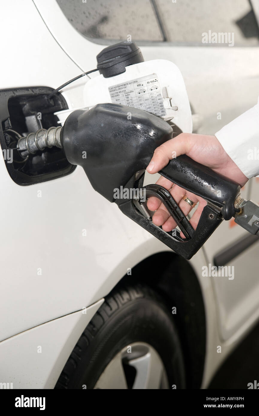 A hand of a man filling up unleaded petrol at a petrol station Stock ...