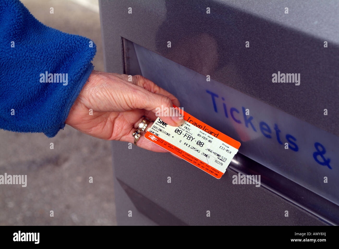 Customers Hand with Two Part Return Tickets for use with South West Trains Self Service Railway Ticket Machine Dispenser Stock Photo