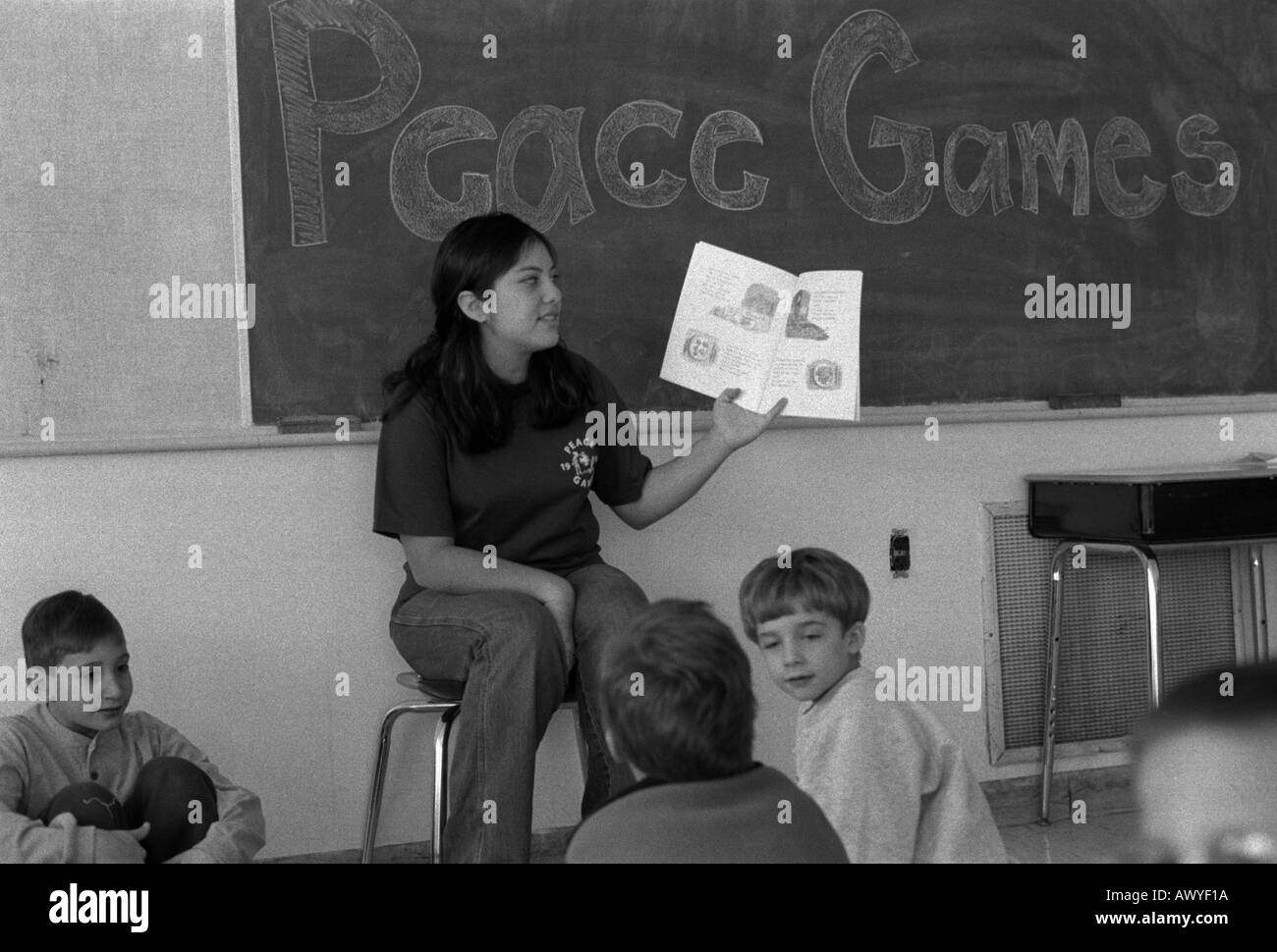 Peacegame s volunteer in first grade classroom with tudents Stock Photo