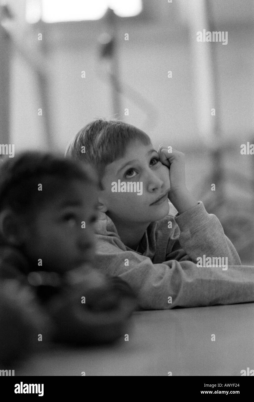 First grader daydreams while the teacher gives a lecture Stock Photo