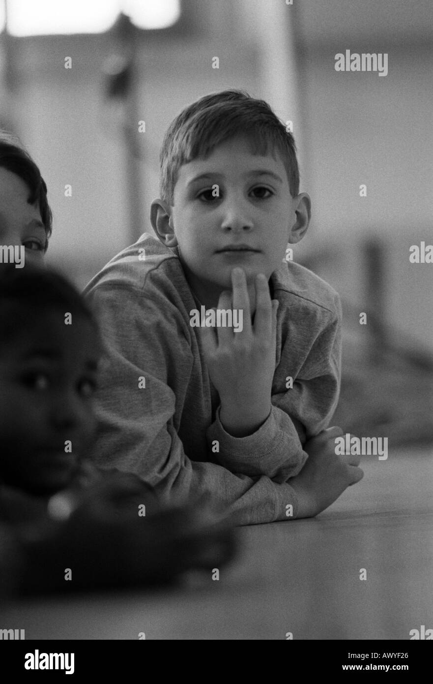 First grader looks at the camera during a teacher s lecture Stock Photo