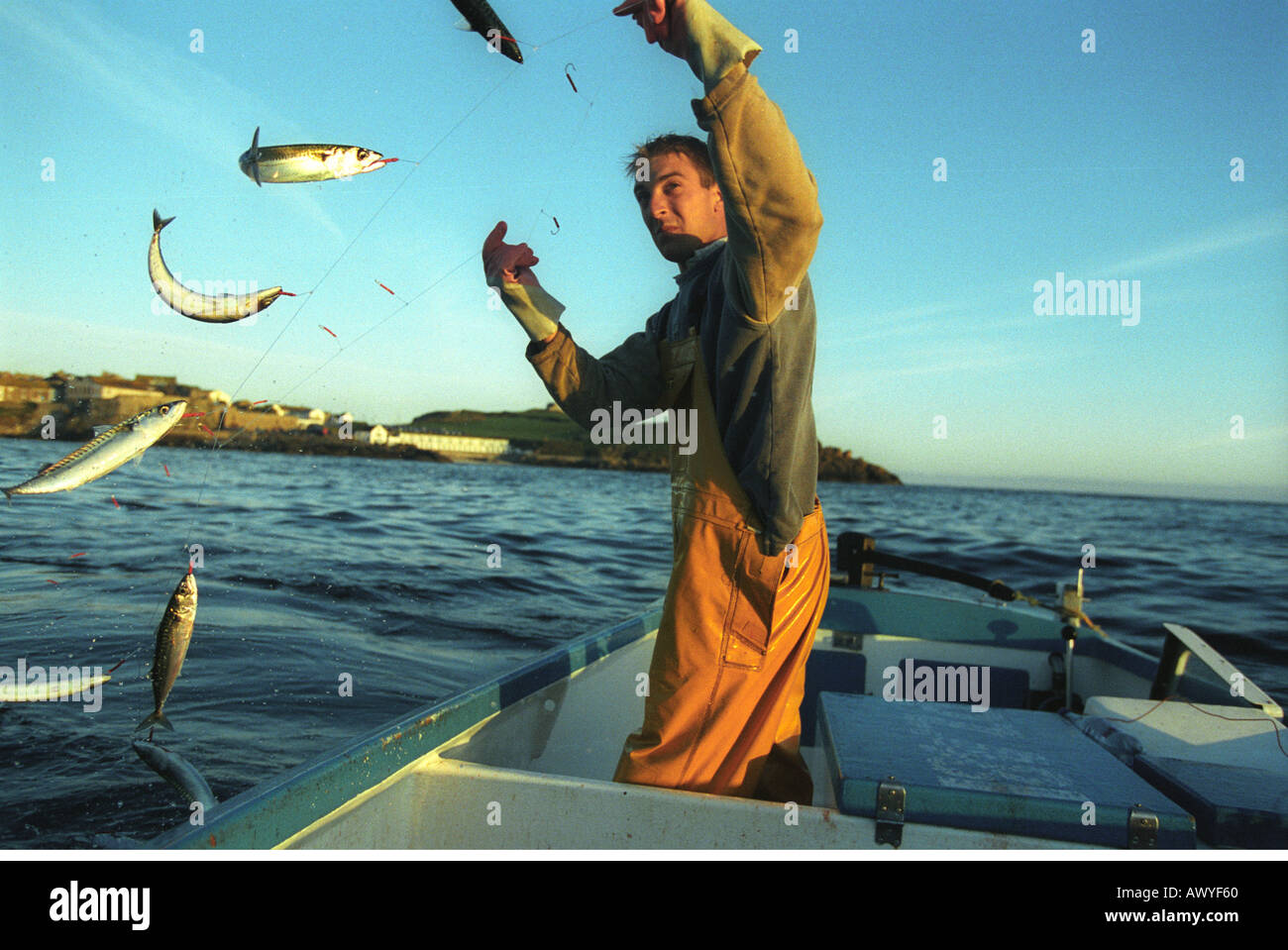 Line Rider Catch Hand line fisherman retrieving a line from behind his boat full of ...