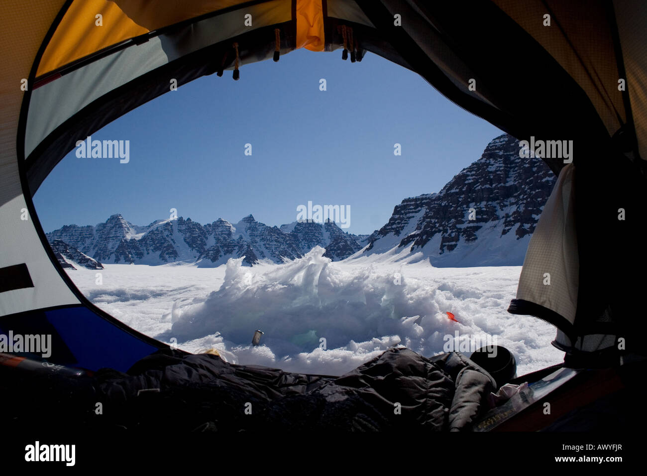 view of the mountains from the sleeping bag out of the tent when camping on a glacier in Greenland Stock Photo