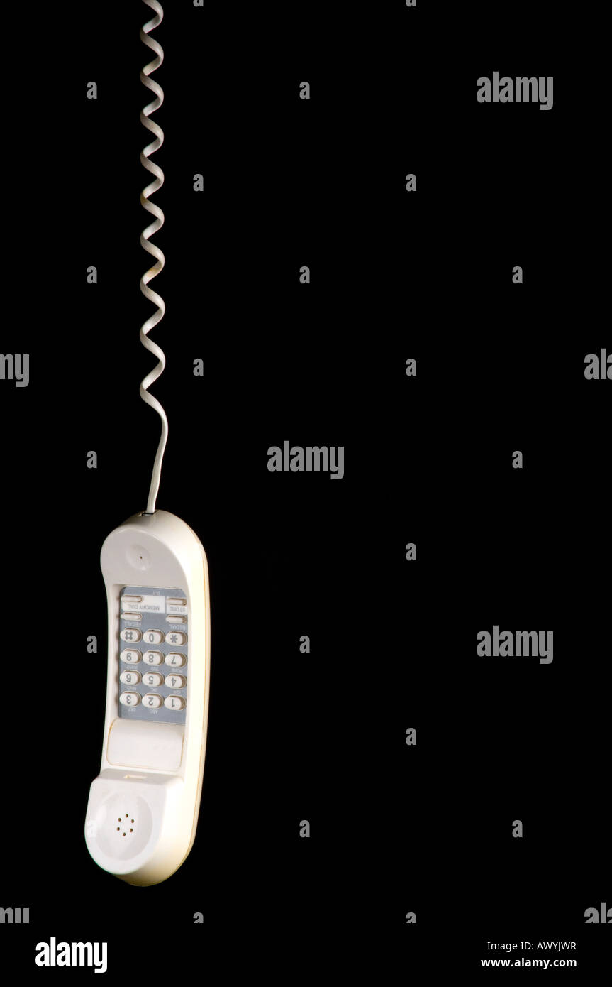White telephone hanging by its wire Stock Photo Alamy
