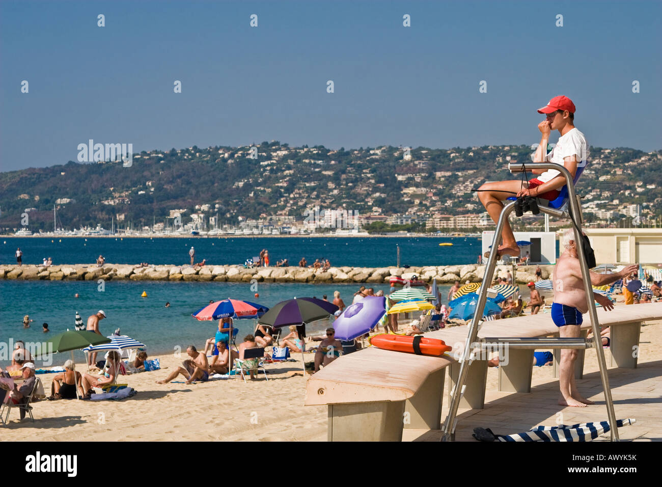 Lifeguard watching over crowded public beach and swimmers Juan les Pins French Riviera Stock Photo