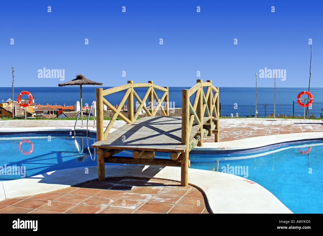 swimming-pool-in-spanish-hotel-with-sea-views-and-palm-trees-stock