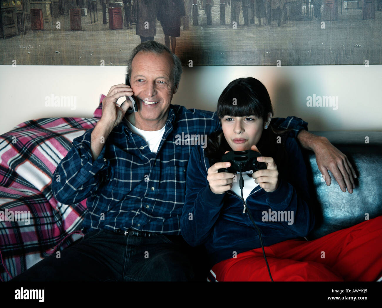 Grandfather and granddaughter watching television Stock Photo