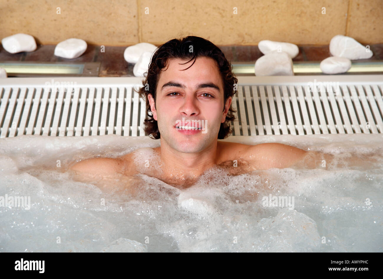Young man in jacuzzi at a spa Stock Photo - Alamy