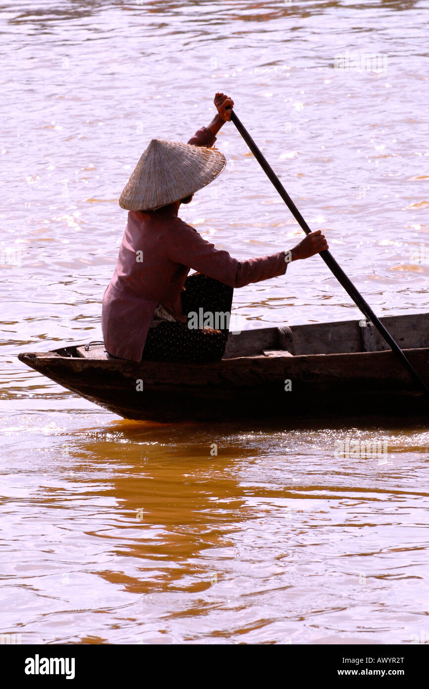 Vietnam Hoi An Market Young Woman In National Dress Non Bai Tho Conical Hat Paddles Boat On Thu Bon River At Dusk Vietnam Hoi An Market Young Woman In National Dress Non Bai Tho Conical Hat Paddles Boat On Thu Bon River At Dusk