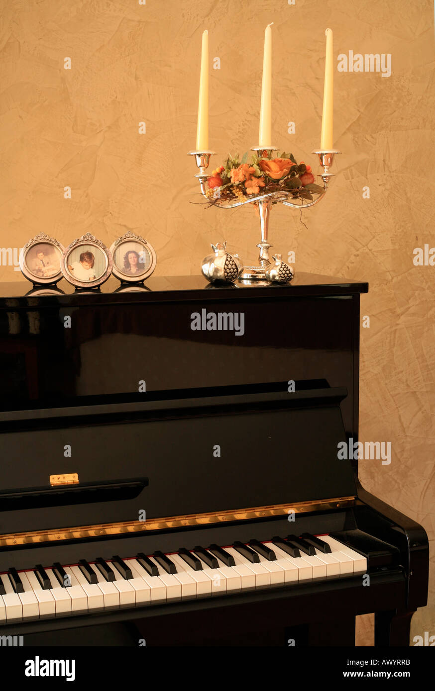 Piano decorated with photos and candelabra Stock Photo Alamy