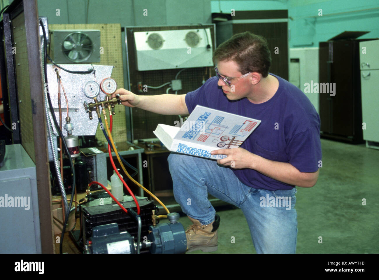 Male Student learns refrigeration and air conditioning repair Stock Photo