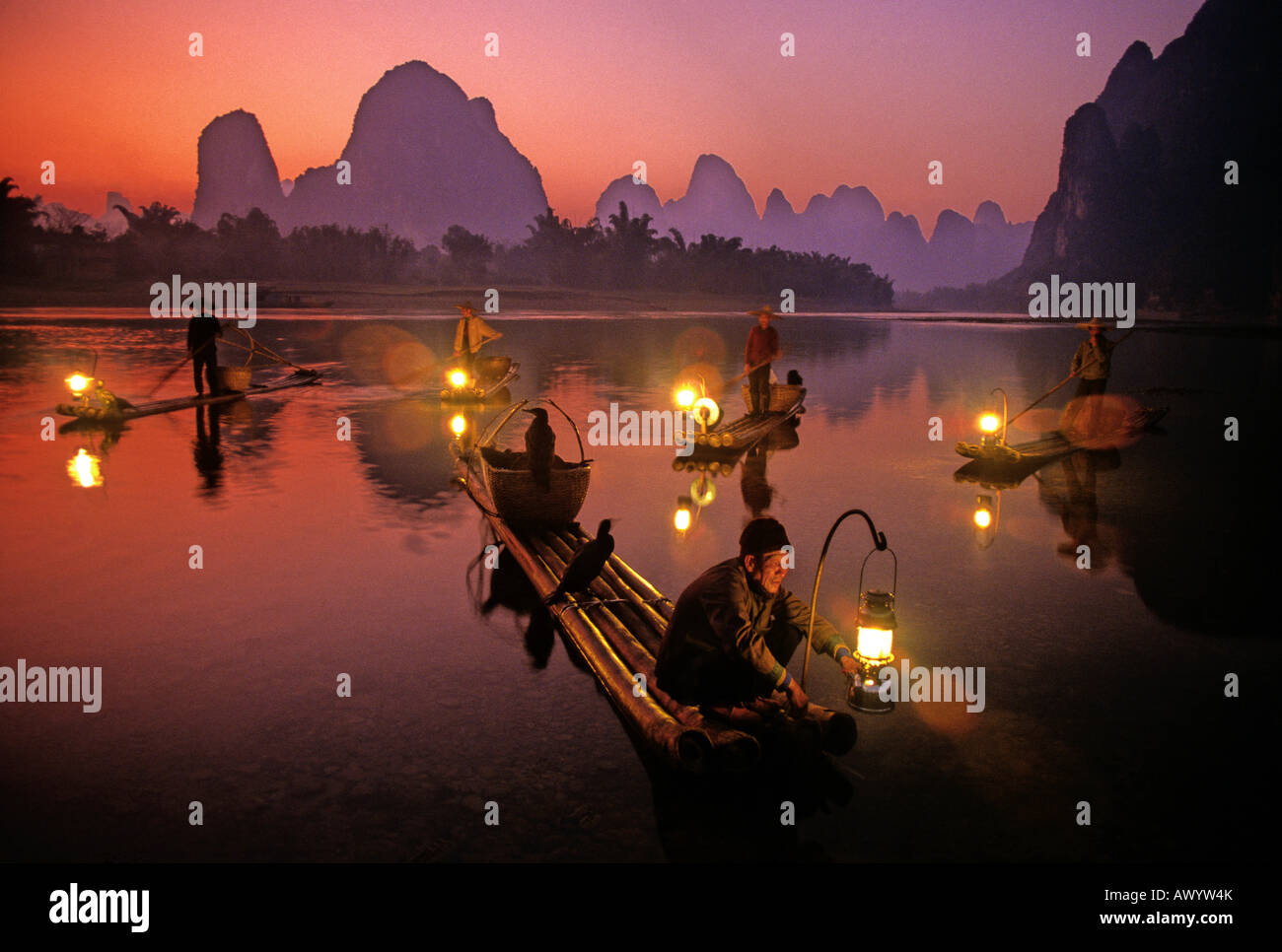 Cormorant fishermen lighting lanterns for night fishing on Li River at  Xingping in Guilin area of China Stock Photo - Alamy