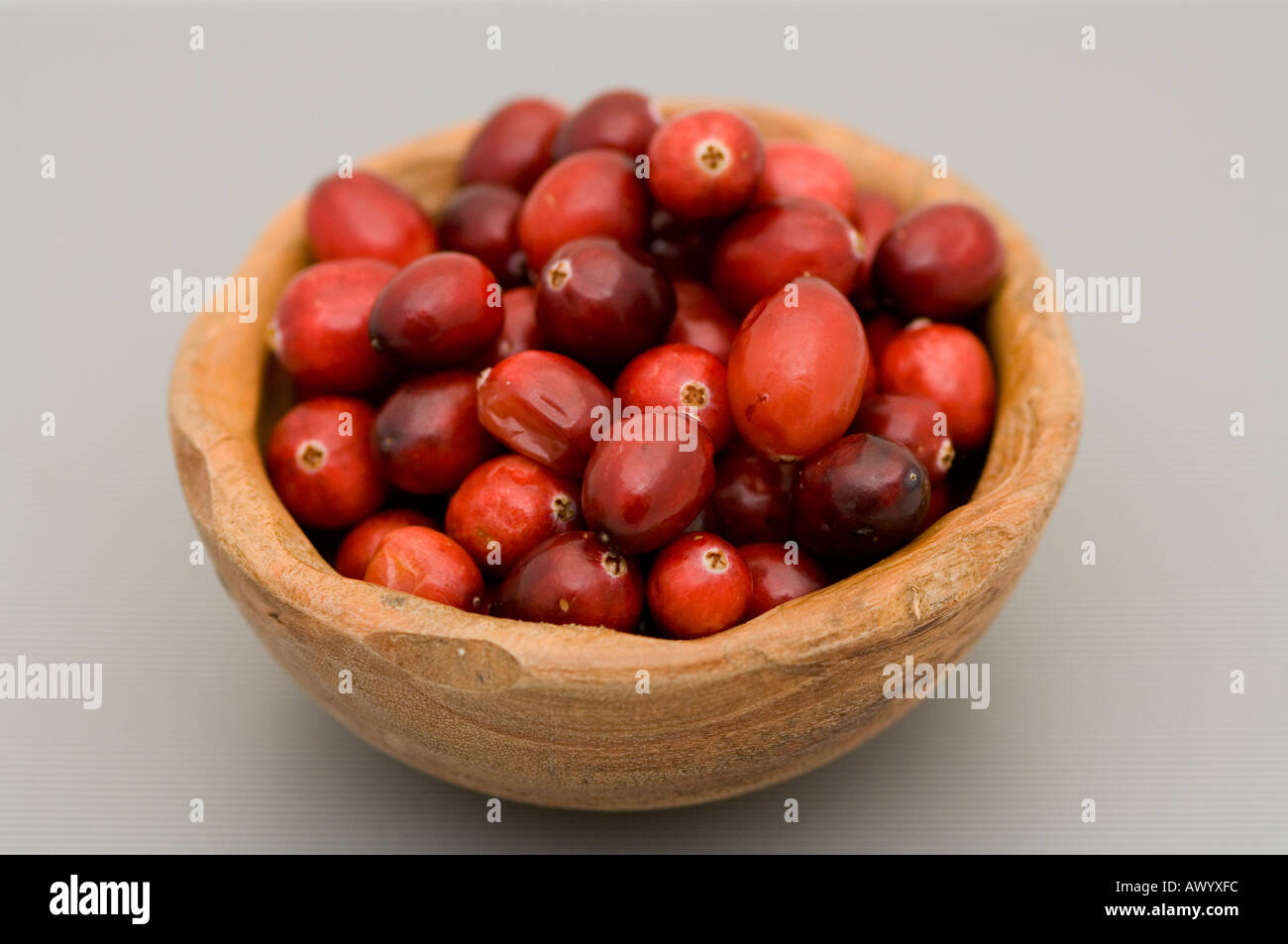 Fresh cranberries in a wooden bowl Stock Photo