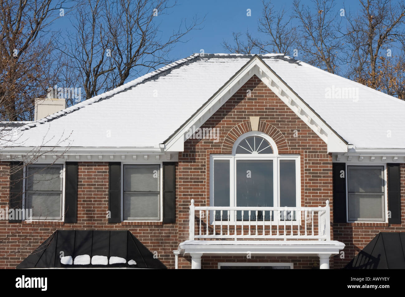 A brick house is shown against a blue sky Stock Photo - Alamy