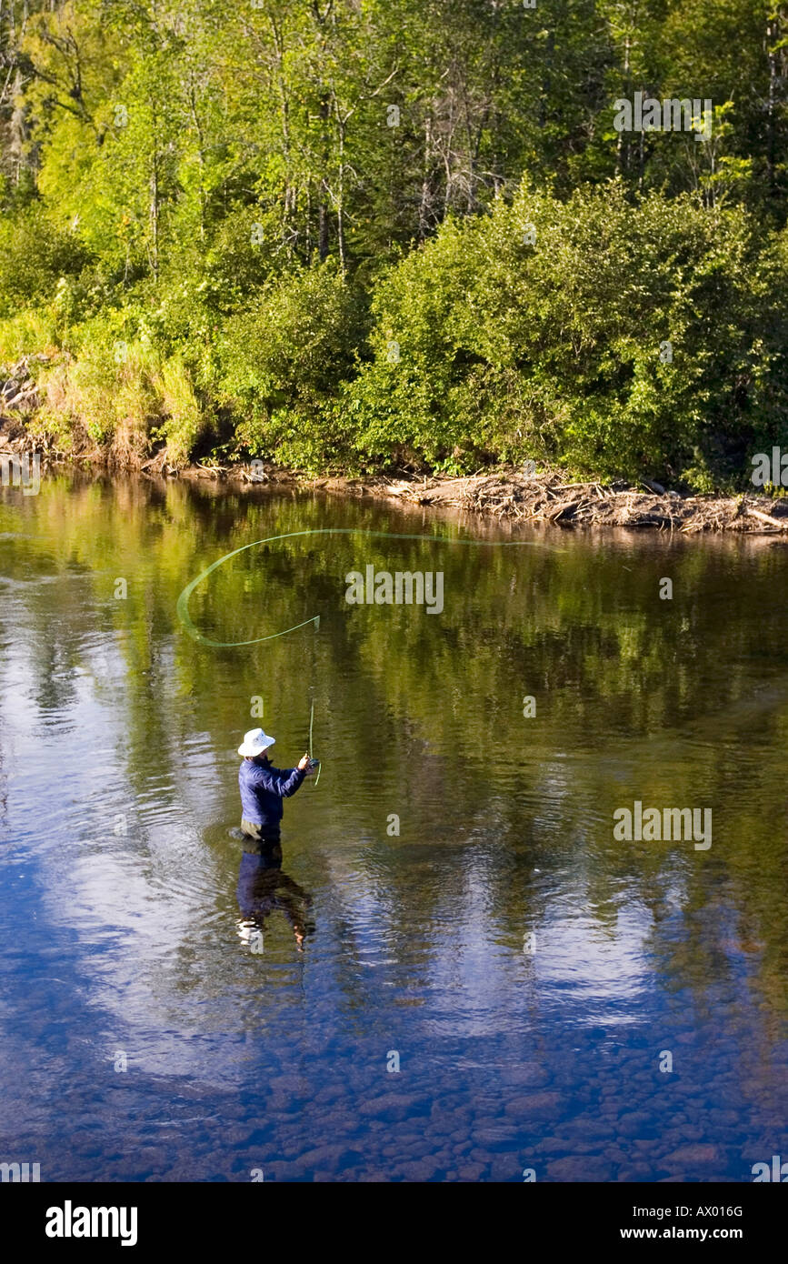 Fly fisherman fishing for atlantic salmon in Ste Marguerite river Stock ...