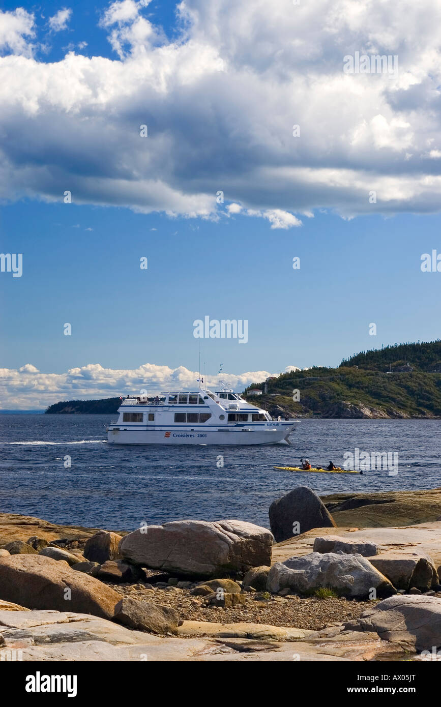 'Croisières 2001' whale watching cruising ship passing in front of two kayakers on the Saguenay river at Tadoussac Stock Photo