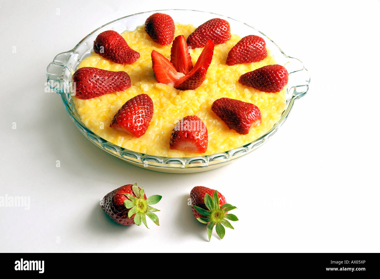 Dish with rice pudding decorated with strawberries Stock Photo