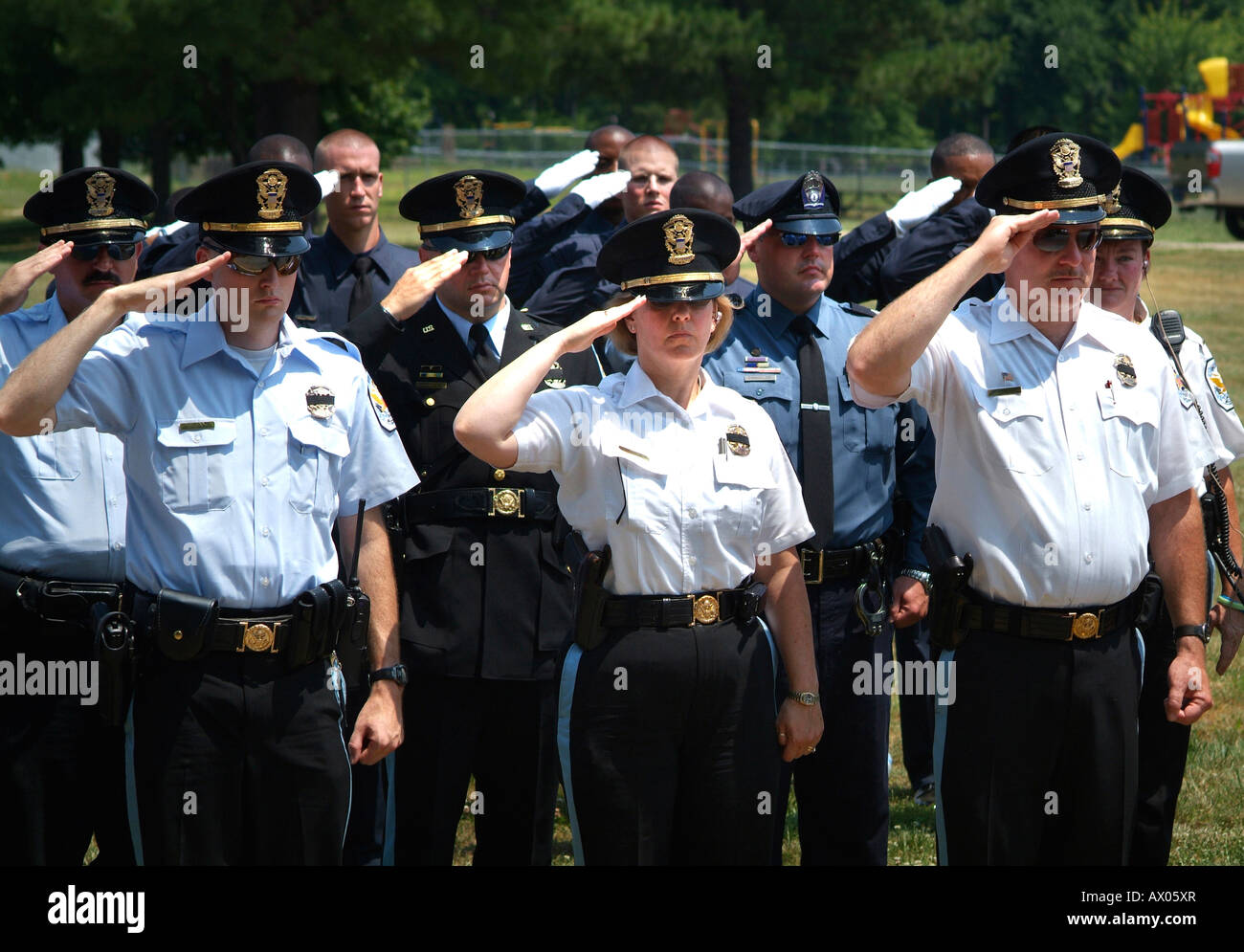 Police saluting at policeman s funeral Stock Photo